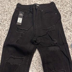 Distressed black skinny jeans
